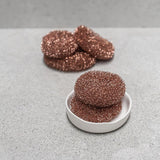 Copper scrubbies on a white plate against a gray background