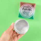 Hand holding a container of putty with packaging labeled 'Super Fun Putty' on a green background
