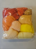 Pack of multicolored yarns in a clear plastic bag on a white background
